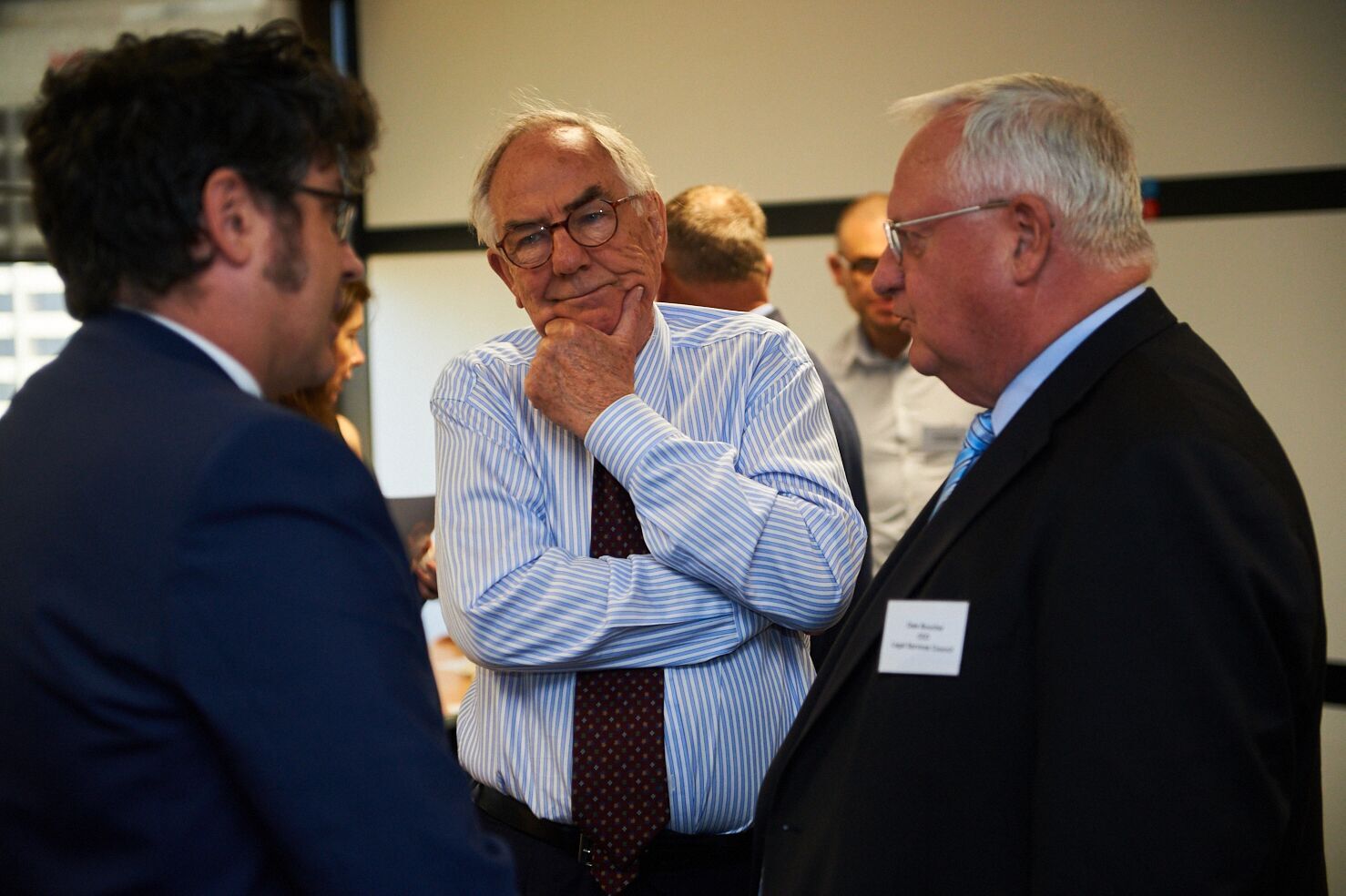 Mr ​​Matt Dunn, Mr Michael Black AC QC and Mr Dale Boucher are talking to each other.